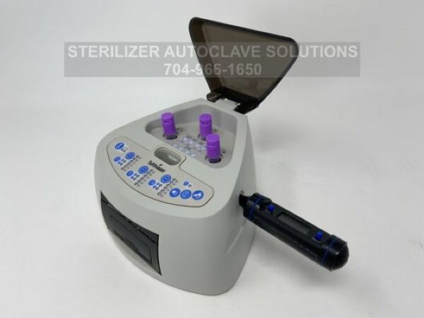 The Tuttnauer Minibio shown with the lid open showing the bio-indicators (not included) and the temperature sensor (included) in place.