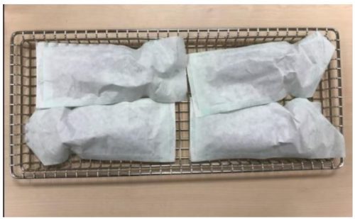 The proper way to load pouches on a tray for sterilization in the Tuttnauer T-edge sterilizer.