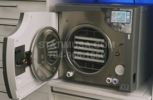 This is the SciCan Bravo G4 Chamber Autoclave with the door open showing the trays.